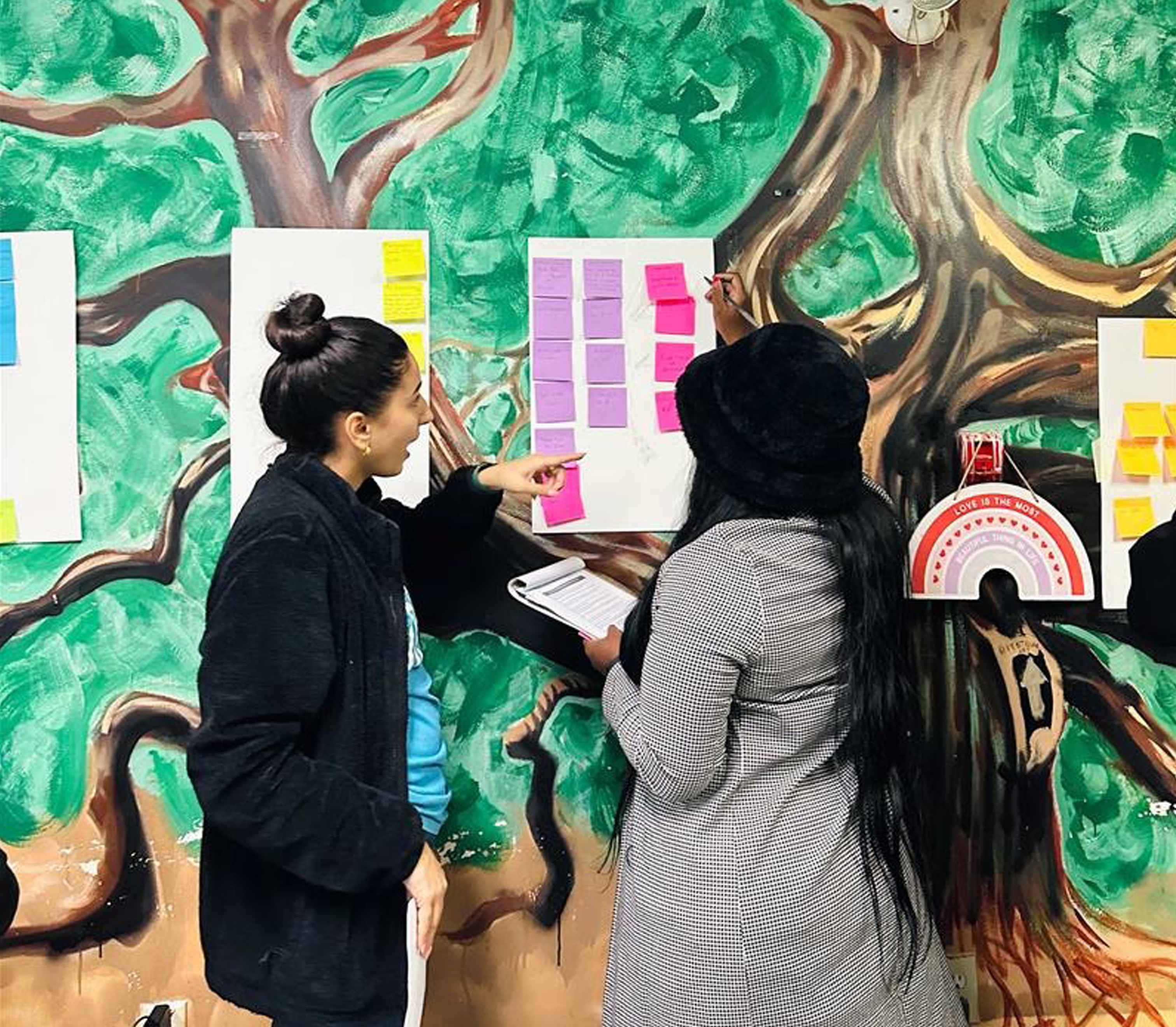 Women in BOLT program looking at chart on wall