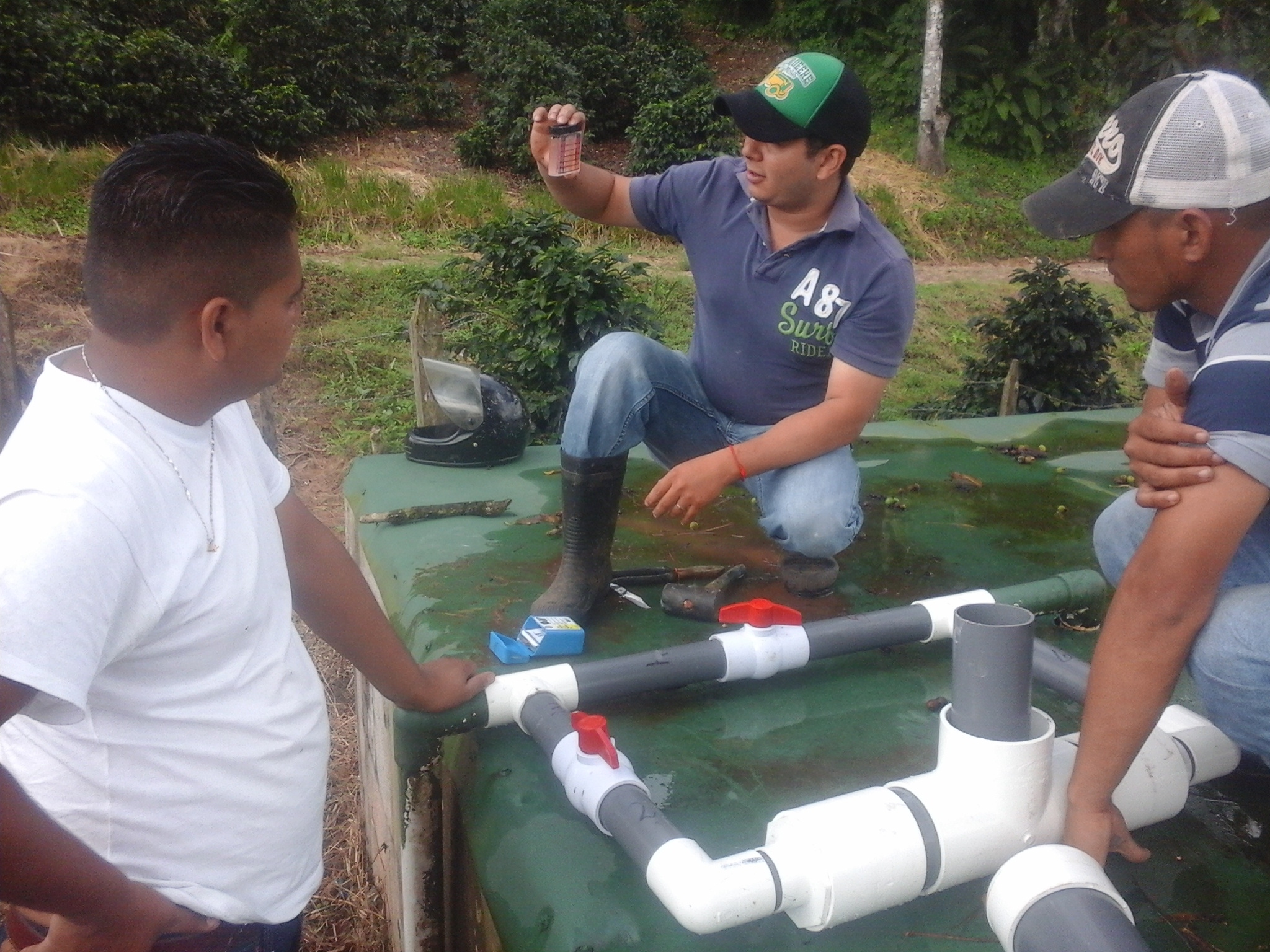 Three men at a water purification site testing water quality. 