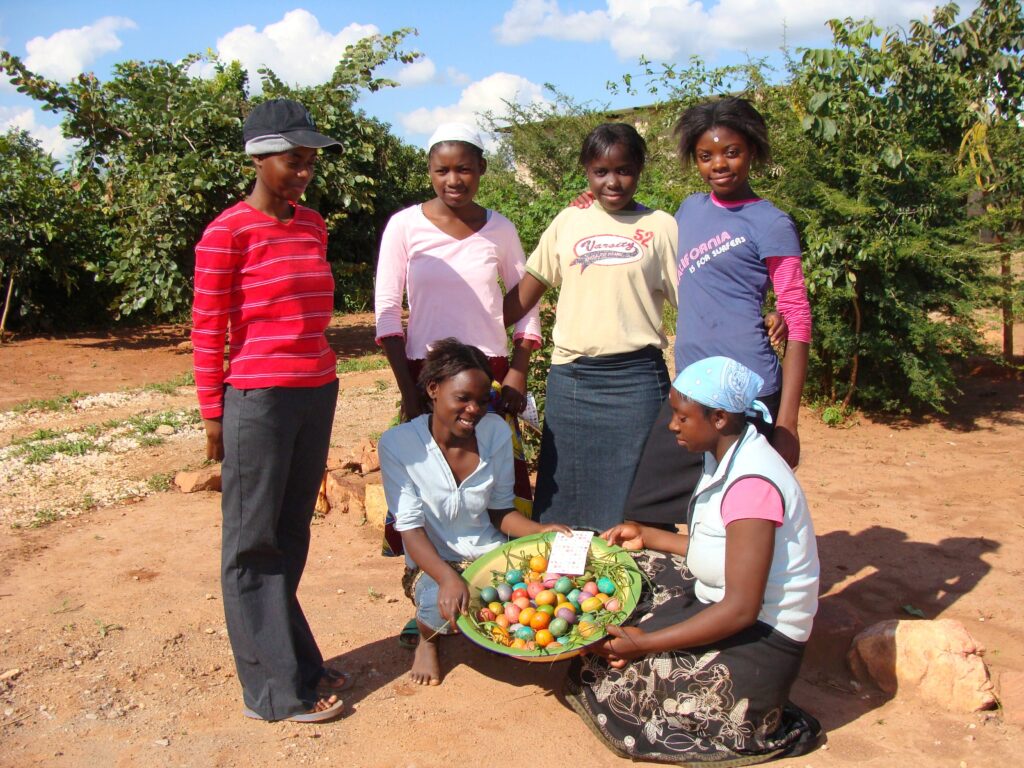 Group of young women with eggs at the farm.